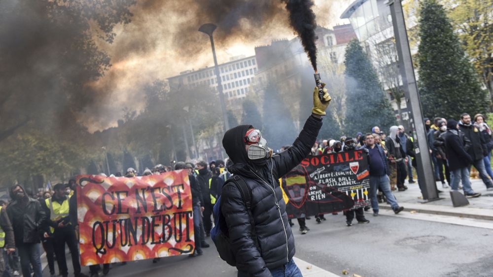 A protestor waves a flareGilets Jaunes anniversary protest, Nantes, France - 16 Nov 2019