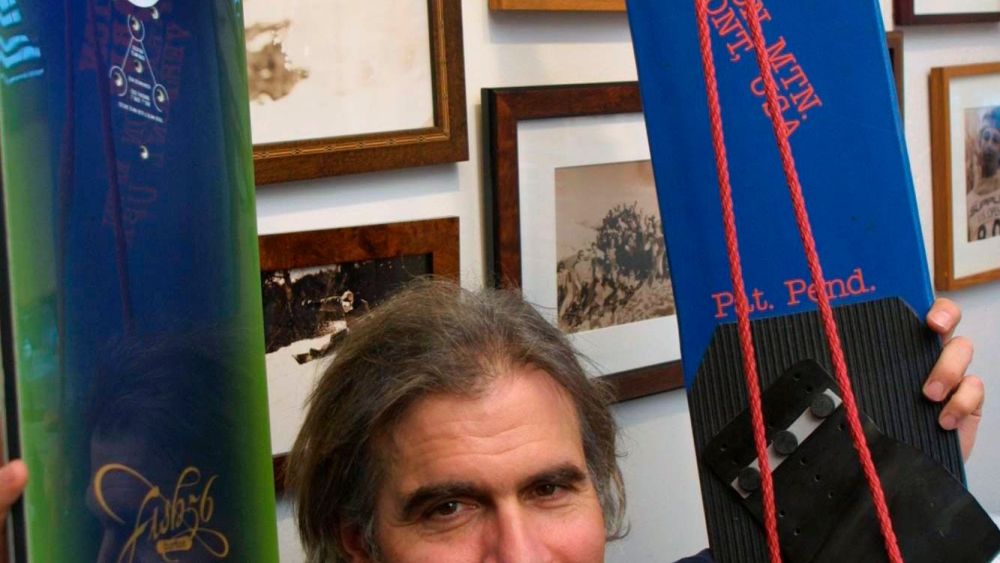 JAKE BURTON CARPENTER. Jake Burton Carpenter, owner of Burton Snowboards, shows an early model, right, and one of the newer snowboards, left, in his office in Burlington, Vt. Carpenter, the innovator who brought the snowboard to the masses and helped turn the sport into a billion-dollar business, has died after a recurring bout with cancer. He was 65. Officials from the company he founded, Burton Snowboards, told The Associated Press of his deathObit Jake Burton, BURLINGTON, USA - 08 Mar 2002
