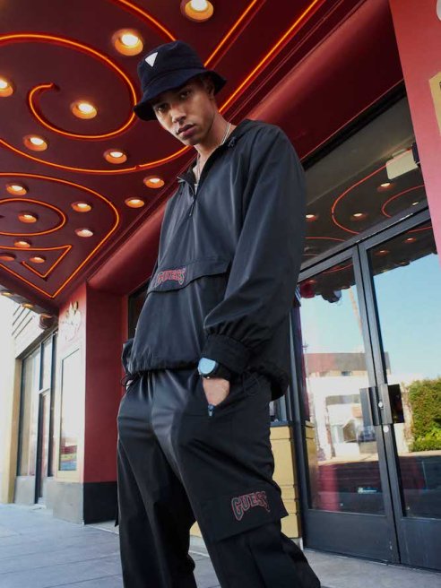 Guess Inc. CEO Carlos Alberini said the company plans to close about 100 global stores over the next 18 months but lamented e-commerce woes.