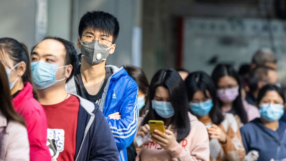 People in Guangzhou line up to buy masks.