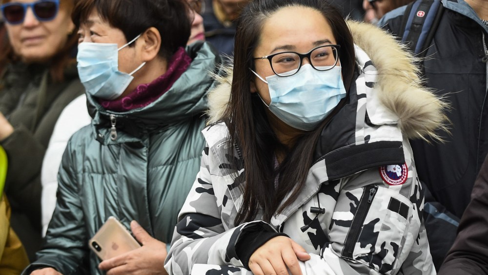 Members of the public wearing facemasks await dragon and lion dancers and traditional costumed characters taking part in a parade as part of the Chinese New Year celebrations in Chinatown to celebrate the Year of the Rat. Chinese New Year in the capital draws hundreds of thousands of Londoners and tourists and is the biggest such celebration outside Asia.Chinese Lunar New Year celebrations, London, UK - 26 Jan 2020This year's event takes place in the shadow of an outbreak of the coronavirus in Wuhan, China, which has so far claimed the lives of 56 people.