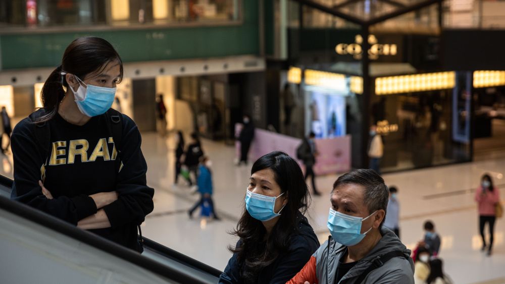 People wear face masks at a shopping mall in Hong Kong.