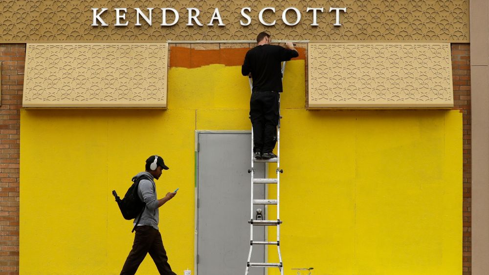 Worker paints plywood as a boarded-up store is prepared for potentially prolonged closure due to the coronavirus pandemic in Kansas City, Mo. The jewelry store was one of several in the Country Club Plaza shopping center that was secured as Kansas City and surrounding counties begin a mandatory stay-at-home order to begin at midnight tonight in an effort to stem the spread of COVID-19Virus Outbreak Missouri, Kansas City, United States - 23 Mar 2020
