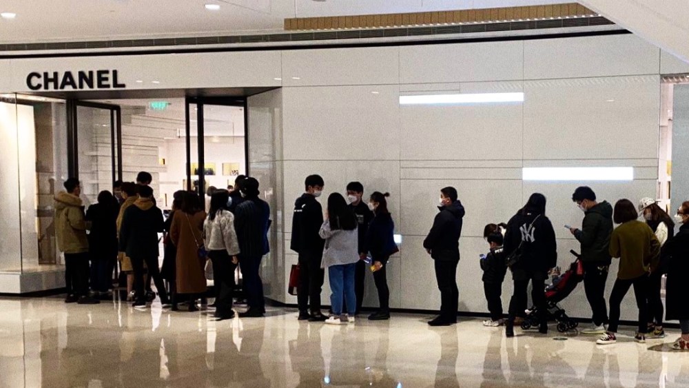 People are queuing again to shop in Chanel in Shanghai's Plaza 66 as the outbreak is contained in China.