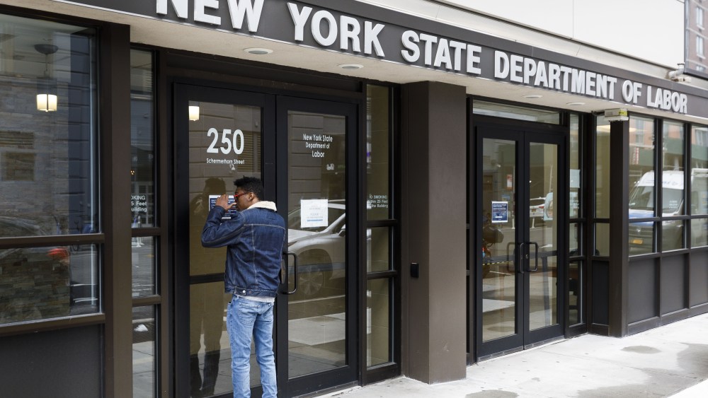 A man looks into the closed offices of the New York State Department of Labor in Brooklyn, New York, USA, on 03 April 2020. The unemployment rate in the United States for March was reported to have risen to 4.4%, according numbers released to day by the U.S. Department of Labor, as the national economy begins to show the large impact from state and city responses to the coronavirus pandemic. New York City is still considered the epicenter of the coronavirus outbreak in the United States and hospital workers dealing with Covid-19 patients are struggling with a limited supply of protective equipment.New York Coronavirus Unemployment, Brooklyn, USA - 03 Apr 2020