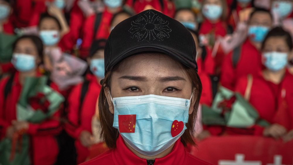A medical worker from The First Bethune Hospital of Jilin University reacts at the airport as she prepares to leave after the lockdown was lifted, in Wuhan, China.