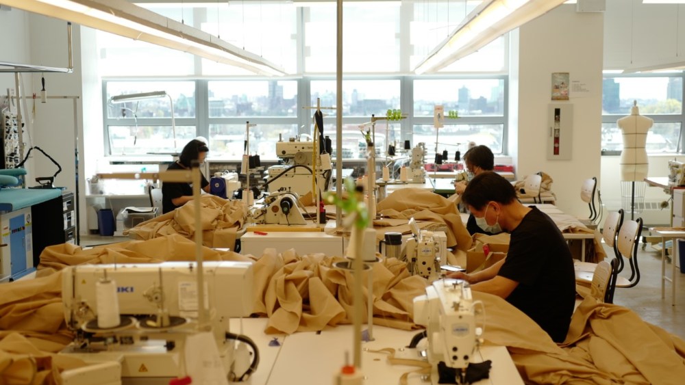 Employees at Lafayette 148 headquarters making hospital gowns, while practicing social distancing.