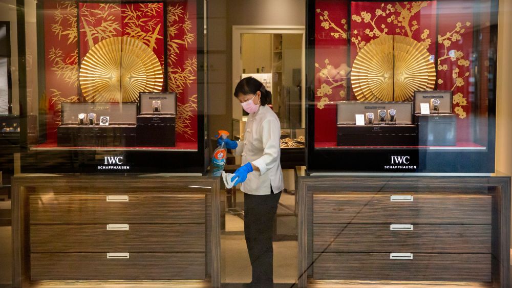 An employee disinfecting an IWC store in Beijing