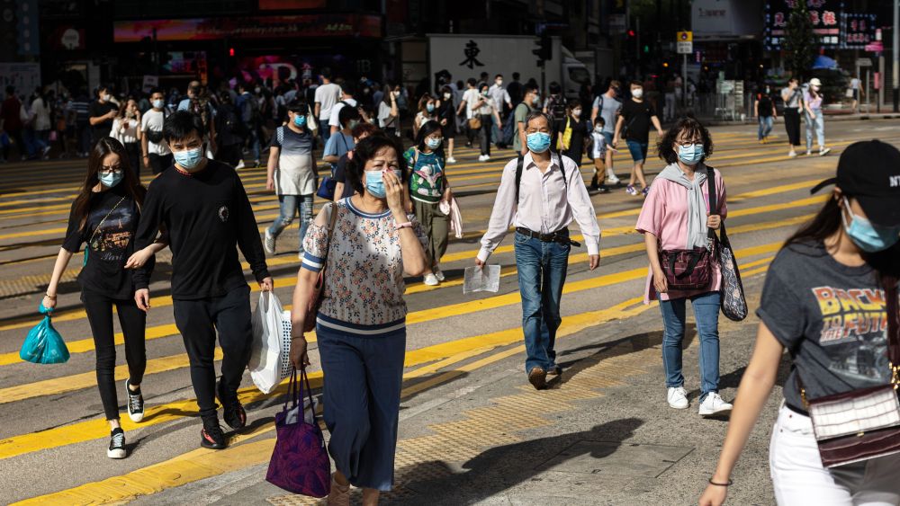 Pedestrians wearing protective face masks cross an intersection on a shopping street in the Causeway Bay district in Hong Kong, China, 05 May 2020, amid the ongoing coronavirus COVID-19 pandemic. From 08 May Hong Kong people will be allowed to go out in groups of up to eight, as a limit on the size of gatherings in public places is relaxed amid a dwindling number of new COVID-19 cases in the city.Coronavirus situation in Hong Kong, China - 05 May 2020
