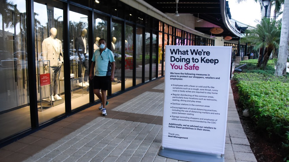 shopper in mask at mall coronavirus signrecautions in place as Phase 1 of retail reopening begins in Broward and Dade County amid the Coronavirus outbreakCoronavirus outbreak business reopening, Sunrise, Florida, USA - 18 May 2020