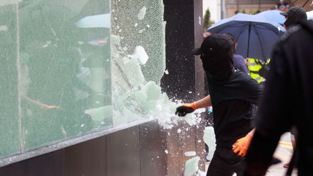 Protesters break the glass of a shop which allegedly support the police during protest against the security law.Protest vs security law in Hong Kong