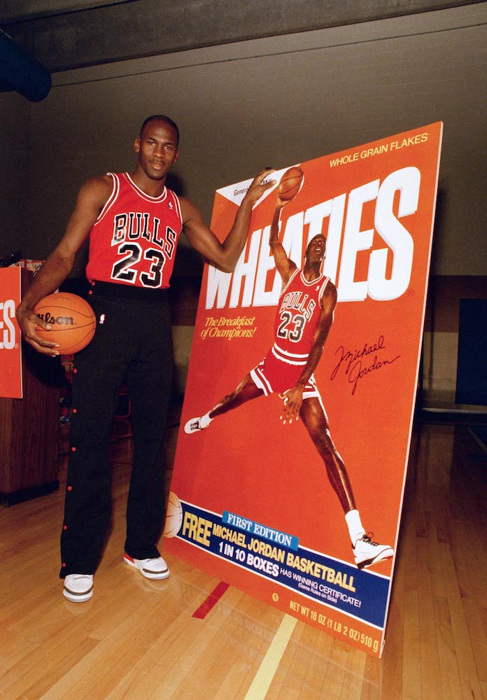 Michael Jordan poses alongside his likeness on a box of Wheaties during an unveiling ceremony in Chicago, . Jordan is the seventh celebrity athlete to have his image displayed on a box of the cereal marketed as "The Breakfast of Champions<br /> Bulls Jordan Wheaties 1988, Chicago, USA