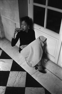Pat Cleveland eating a sandwich backstage during the fashion show to benefit the restoration of the Chateau of Versailles, five American designers matching talents with five French couturiers at the Versailles Palace on November 28, 1973 in Versailles, France...Article title: 'One night and pouf! It's gone!Battle of Versailles, Versailles