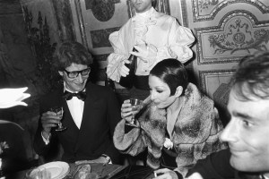 Yves Saint Laurent and friends attend the fashion show to benefit the restoration of the Chateau of Versailles, five American designers matching talents with five French couturiers at the Versailles Palace on November 28, 1973 in Versailles, France...Article title: 'One night and pouf! It's gone!Battle of Versailles, Versailles