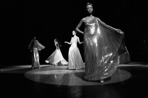 Outtake; Models in costume stand onstage during the fashion show to benefit the restoration of the Chateau of Versailles, five American designers matching talents with five French couturiers at the Versailles Palace on November 28, 1973 in Versailles, France.Article title: "One night and pouf! It's gone!"