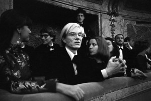 Outtake; Artist Andy Warhol sits with designer Yves Saint Laurent, Mary Russell and Pierre Berge during the fashion show to benefit the restoration of the Chateau of Versailles, five American designers matching talents with five French couturiers at the Versailles Palace on November 28, 1973 in Versailles, France...Article title: "One night and pouf! It's gone!"