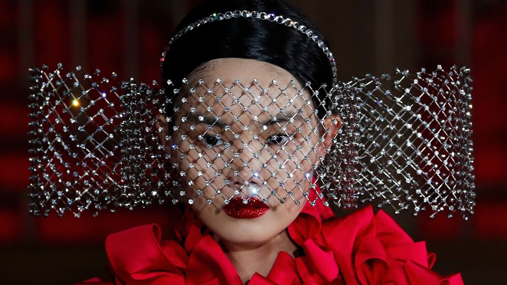 A model presents a creation from Valentino Haute Couture collection by designer Pierpaolo Piccioli during a fashion show at the Aman Summer Palace in Beijing.