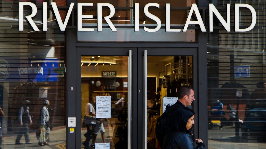 Shoppers walk past a River Island store in north London.