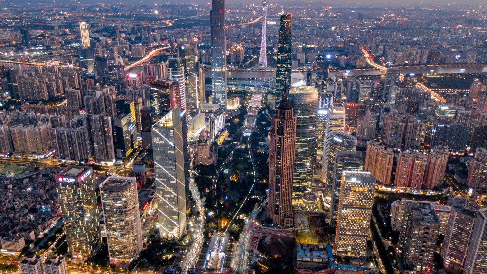 An aerial night view of the Zhujiang New Town with clusters of skyscrapers and high-rise building along the Pearl River in Guangzhou.