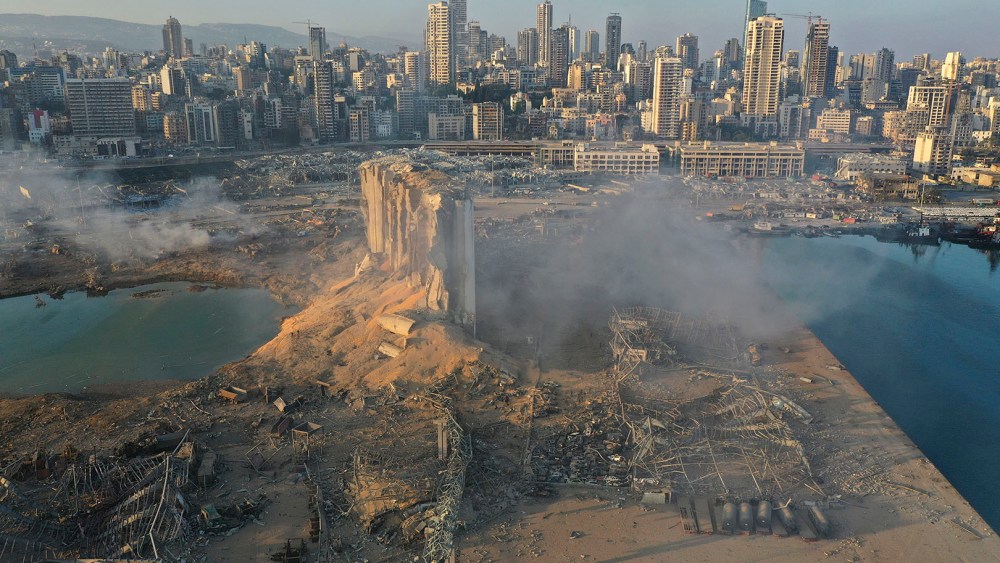 A drone picture shows the scene of an explosion at the seaport of Beirut, Lebanon, Wednesday, Aug. 5, 2020. A massive explosion rocked Beirut on Tuesday, flattening much of the city's port, damaging buildings across the capital and sending a giant mushroom cloud into the sky. More than 70 people were killed and 3,000 injured, with bodies buried in the rubble, officials said. (AP Photo/Hussein Malla)