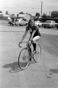 A woman riding a bike in a parking lot in California, 1972.