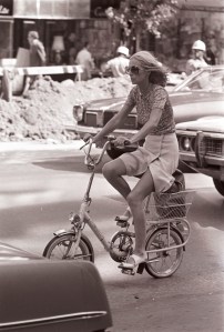 A woman riding a bicycle on the street in New York, 1973.