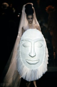 An African Tribal inspired shield-bouquet couture bridal ensemble designed by Jean Paul Gaultier for Spring 2005.