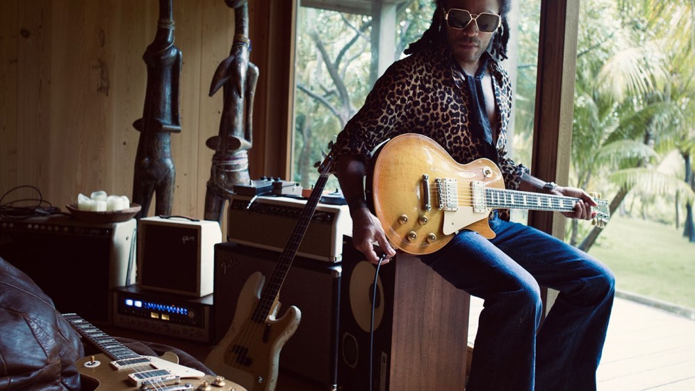 Saint Laurent's shirt and scarf and Kravitz's custom jeans. Prototype sunglasses.