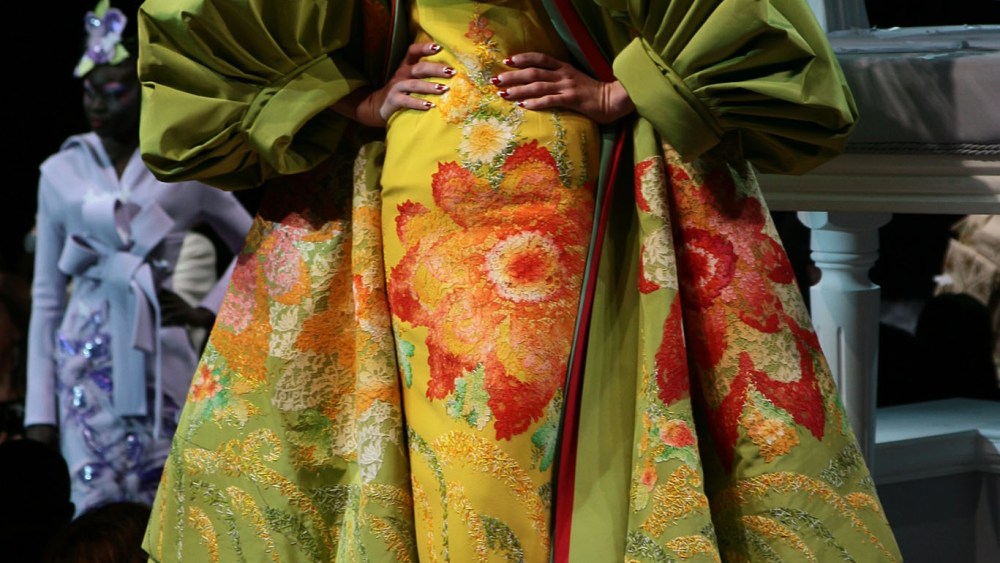 A model poses in an ensemble from Dior's "Madame Butterfly" collection designed by John Galliano at the Polo de Paris.