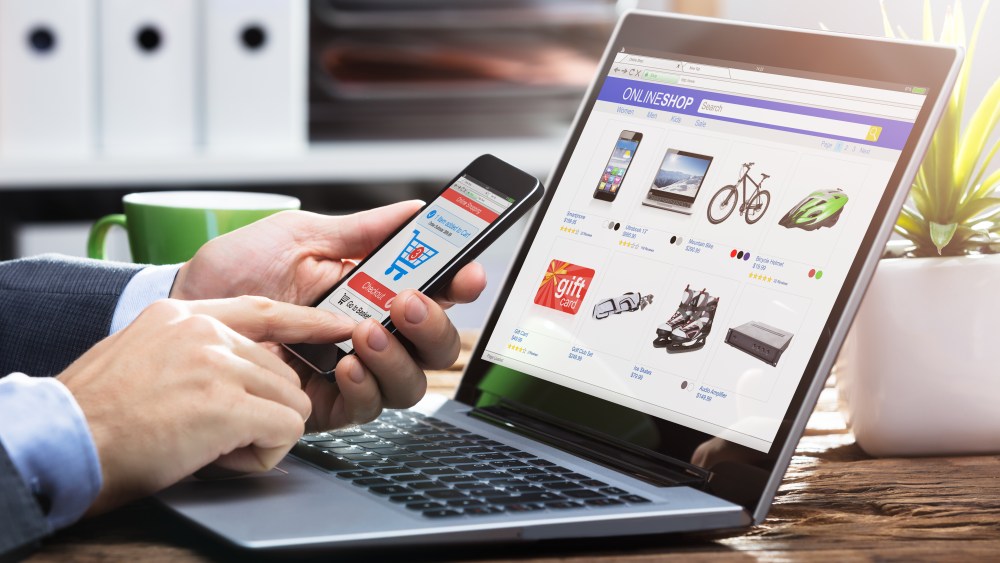 Close-up Of A Businessperson's Hand Doing Online Shopping On Smartphone