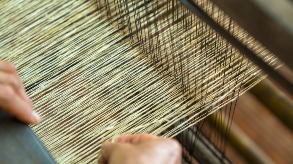 Weaving silk in traditional way in Vietnam. Vietnamese silk processing.