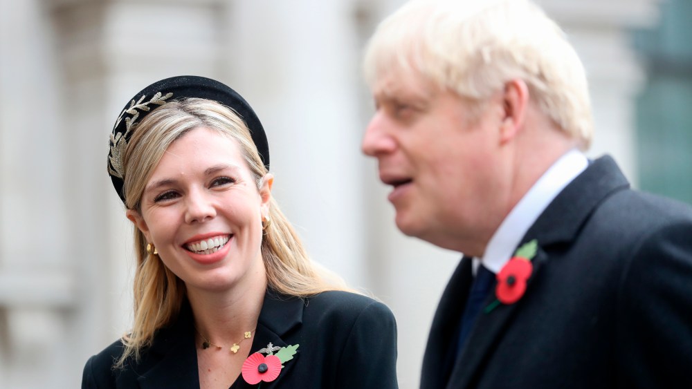 Remembrance Sunday. Prime Minister Boris Johnson with partner Carrie Symonds, talking to veterans, following the National Service of Remembrance at the Cenotaph, in Whitehall, London. Picture date: Sunday November 8, 2020. See PA story MEMORIAL Remembrance. Photo credit should read: Chris Jackson/PA Wire URN:56526282 (Press Association via AP Images)