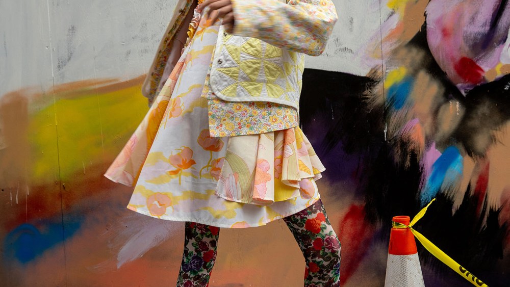 Kelsey Randall’s dress made from deadstock Sixties bedsheets under Matty Bovan’s cotton Liberty denim jacket with metal buttons and Carleen’s vest made from vintage quilts with Shuting Qiu’s tights and heels. Bea Bongiasca earrings; Gaviria necklace; Mounser necklace.