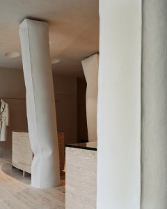 Freestanding pillars are made of gypsum and have the texture of fabric.