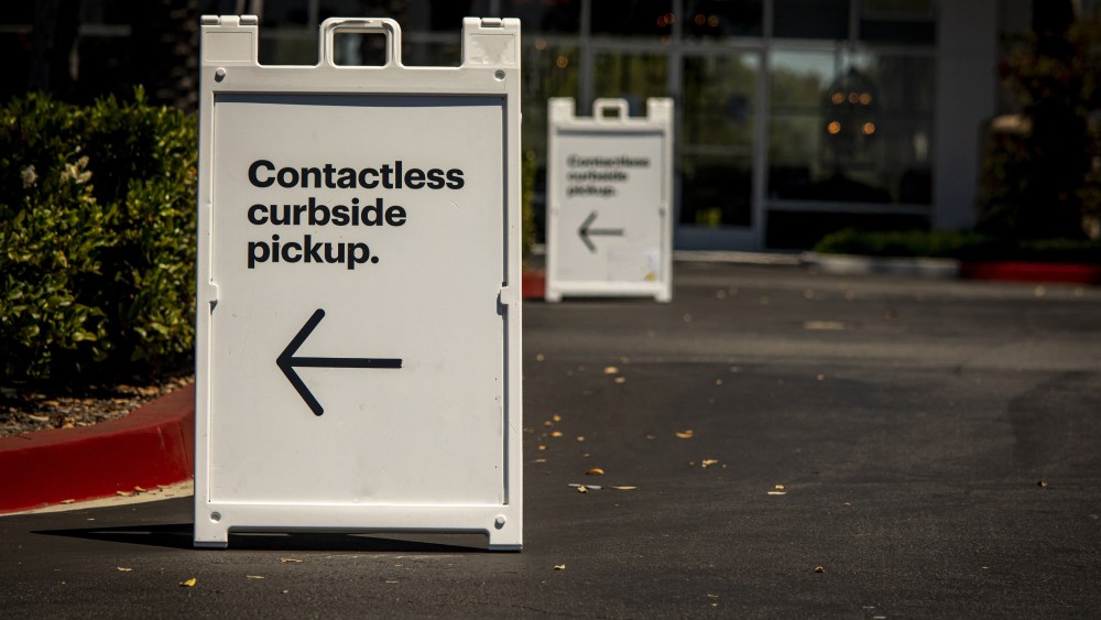 Sign advertising Contactless Curbside Pickup at retail store parking lot