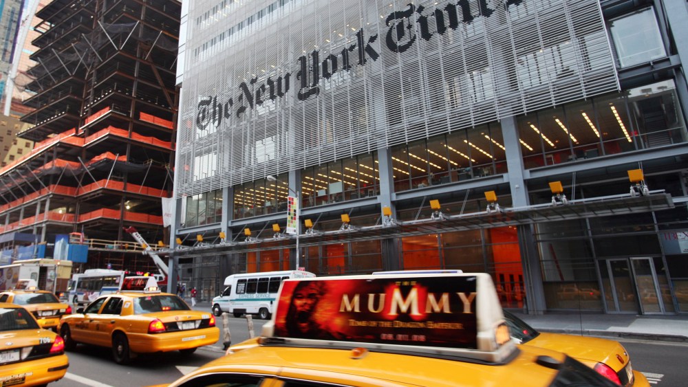 FILE - In this July 22, 2008 file photo, traffic passes in front of The New York Times building in New York. The New York Times says it will charge readers for full access to its Web site starting in 2011, a risky move aimed at drawing more revenue online without driving away advertisers that want the biggest possible audience.(AP Photo/Mark Lennihan, file)