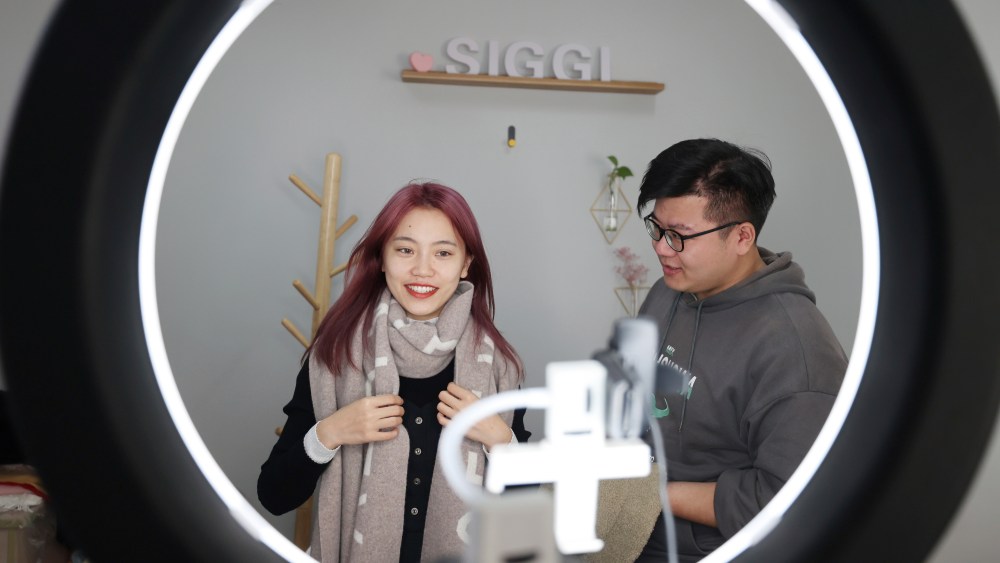 Models livestream in front of a camera at an e-commerce company for the Singles' Day Shopping Festival in Nantong city, east China's Jiangsu province.