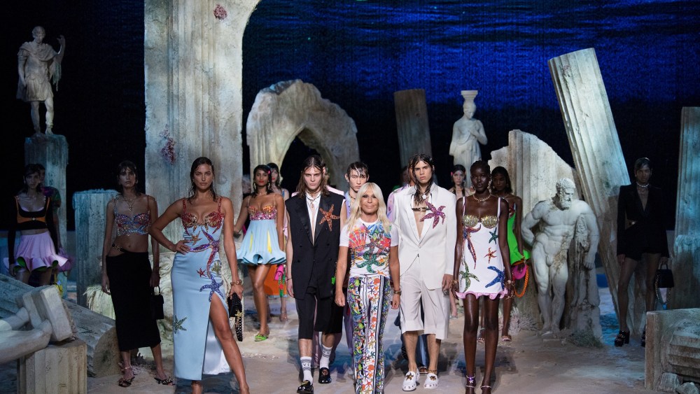 Donatella Versace posing with models on the set of the Versace spring 2021 runway show