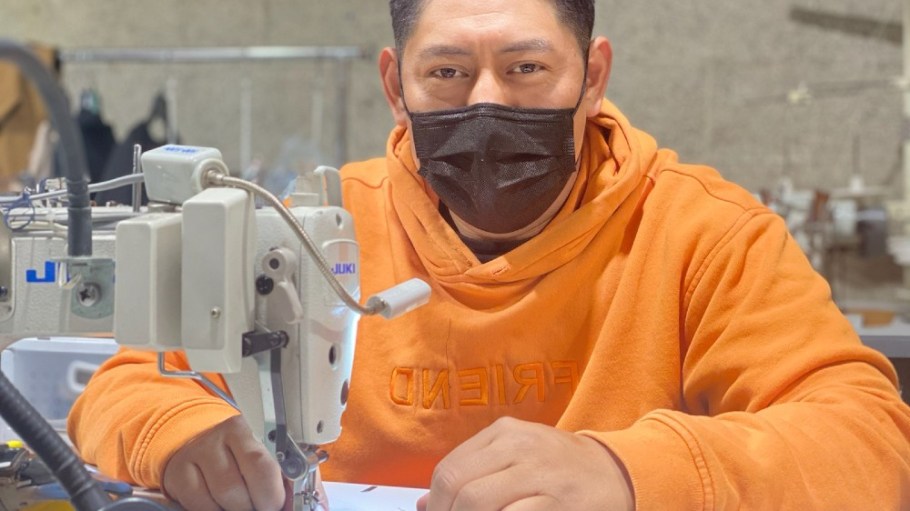 A worker at Los Angeles-based Lefty Production Co. sews a mask.