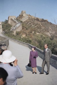 Queen Elizabeth II and Prince Philip pose for a photographers at  the Great Wall of China at Badaling north of  Beijing on Tuesday, Oct. 14, 1986.