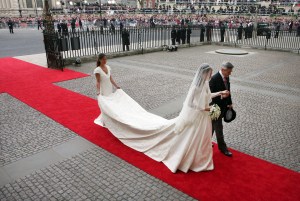 Kate Middleton, center, accompanied by her father Michael Middleton, right, and her sister Pippa Middleton, who is the maid of honour, enter Westminster Abbey ahead of her marriage to Britain's Prince William, London, Friday, April 29, 2011. (AP Photo/Tom Pilston, Pool)