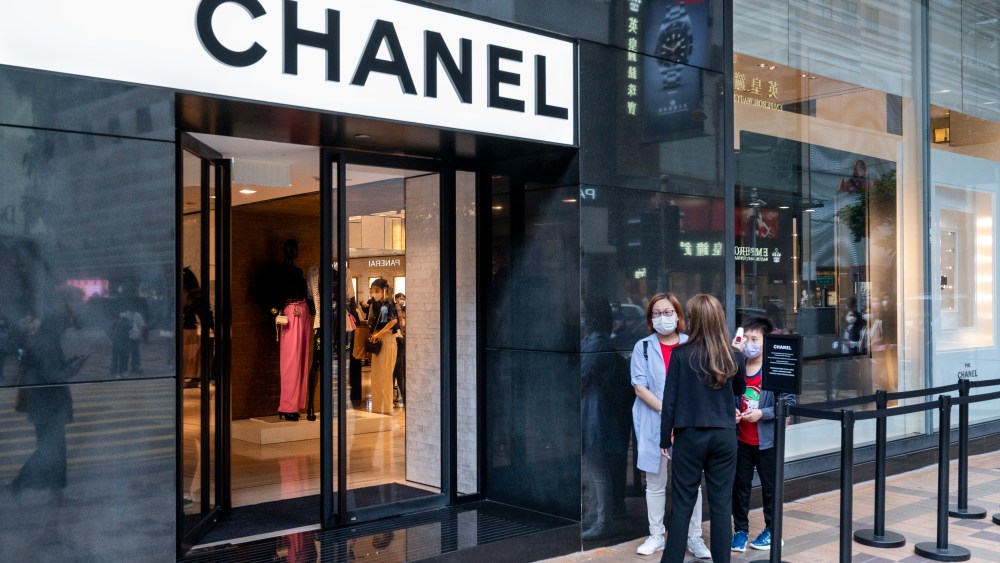 Shoppers in a queue at the entrance of the French multinational Chanel clothing and beauty products brand store seen in Hong Kong. (Photo by Budrul Chukrut / SOPA Images/Sipa USA)(Sipa via AP Images)