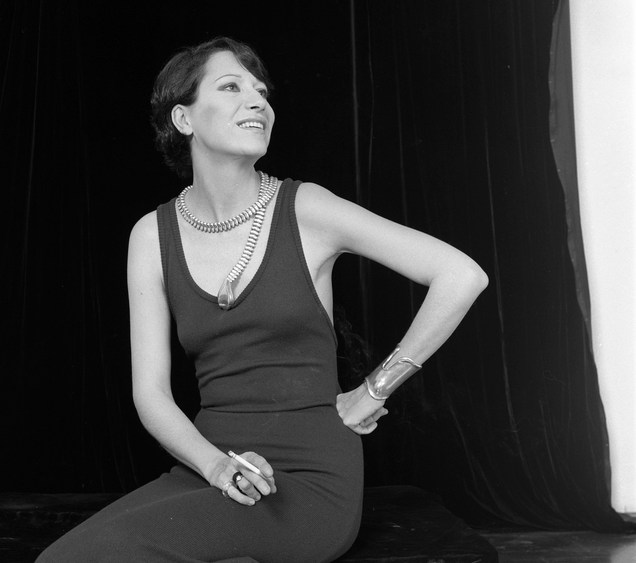 Jewelry designer Elsa Peretti models her snake charmer belt-necklace and bone cuff bracelet.
