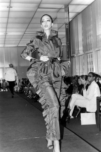 Model Pat Cleveland walks the runway in a silk taffeta ruffled top and pants from Halston's fall 1980 ready to wear collection.