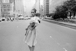 Model Pat Cleveland poses in a silk gazar cocktail dress from Halston's 1981 resort collection on Park Avenue in New York City.