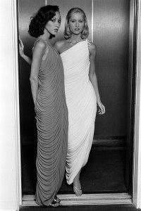 Models Pat Cleveland and Chris Royer pose in the Slink evening dress from Halston's fall 1981 made to order collection advance.