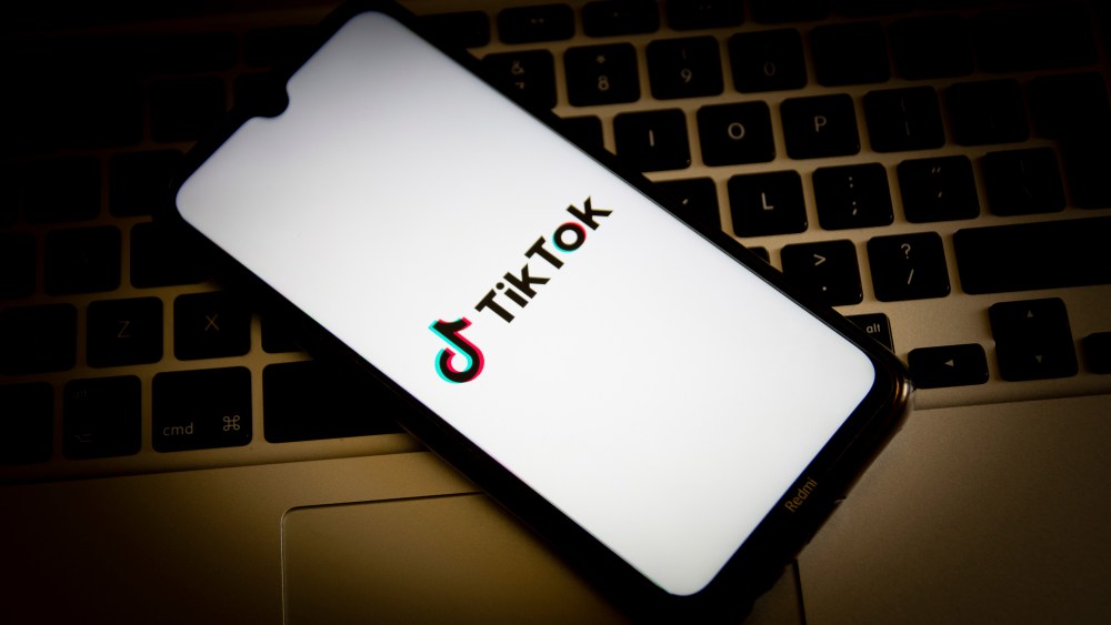 In this photo illustration, a TikTok logo seen displayed on a smartphone screen with a computer keyboard in the background. (Photo by Nikolas Joao Kokovlis / SOPA Images/Sipa USA)(Sipa via AP Images)