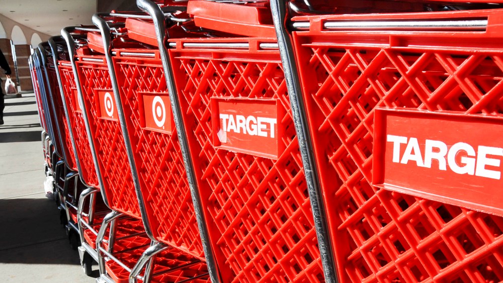 FILE - In this Nov. 17, 2008 file photo, shoppers make their way past Target shopping carts outside the discount retailer in Danvers, Mass. Target Corp. is reporting a 13 percent decline in first-quarter profit as the discounter continues to confront sluggish consumer spending. But the results beat analysts' estimates because of cost-control measures. (AP Photo/Lisa Poole, file)