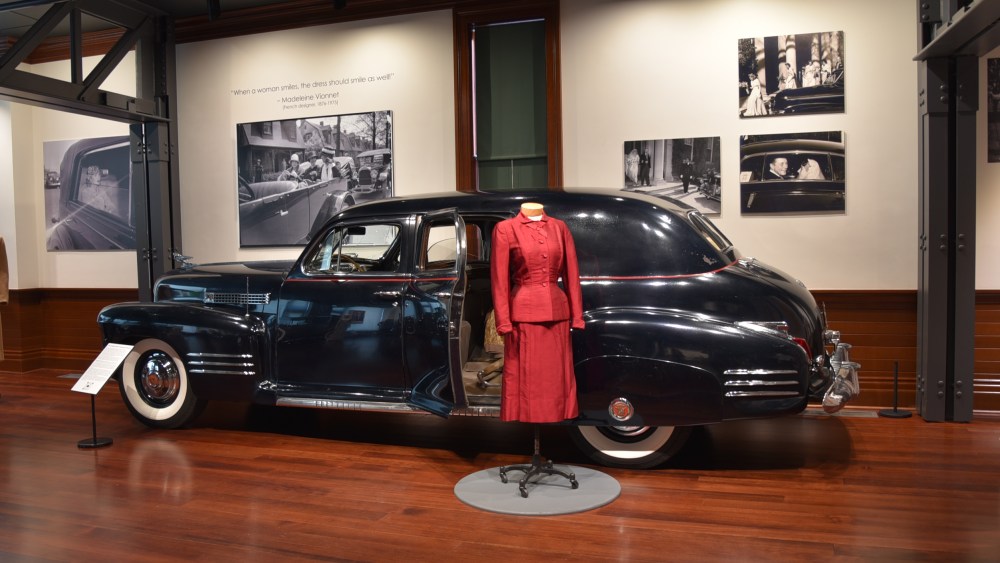 Pictured here is a 1941 Cadillac Series 67 Vanderbilt Limo paired with a tailored red silk suit belonging to Hattie Carnegie of New York.