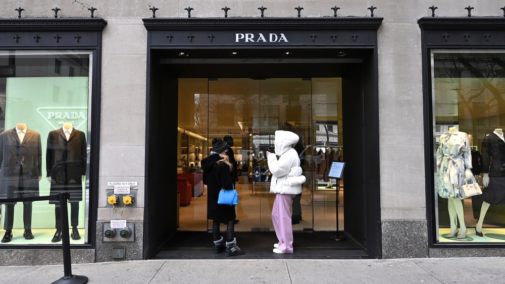 Two women wait outside to enter the Prada Madison Avenue boutique in New York, NY, January 27, 2021. Fashion Week 2021 has started in Paris, France, where fashion designers are showing their Spring 2021 collections in new and imaginative ways despite COVID-19 restrictions such as air travel and a city lockdown for certain times of the day. (Photo by Anthony Behar/Sipa USA)(Sipa via AP Images)